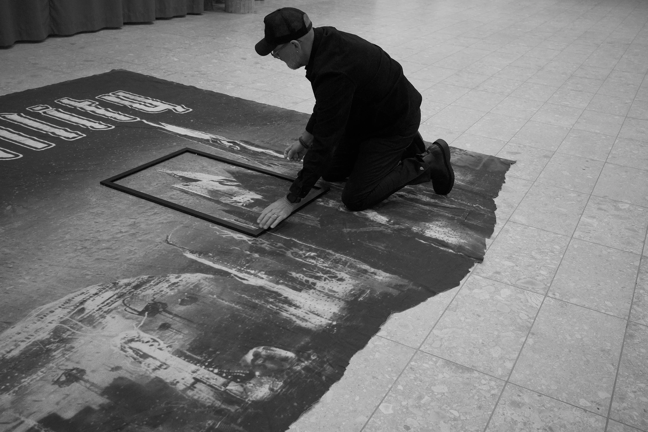 A picture on a man from Whatever LTD. cutting the Dark Tranquillity backdrop from the Character World Tour 2005-2006.